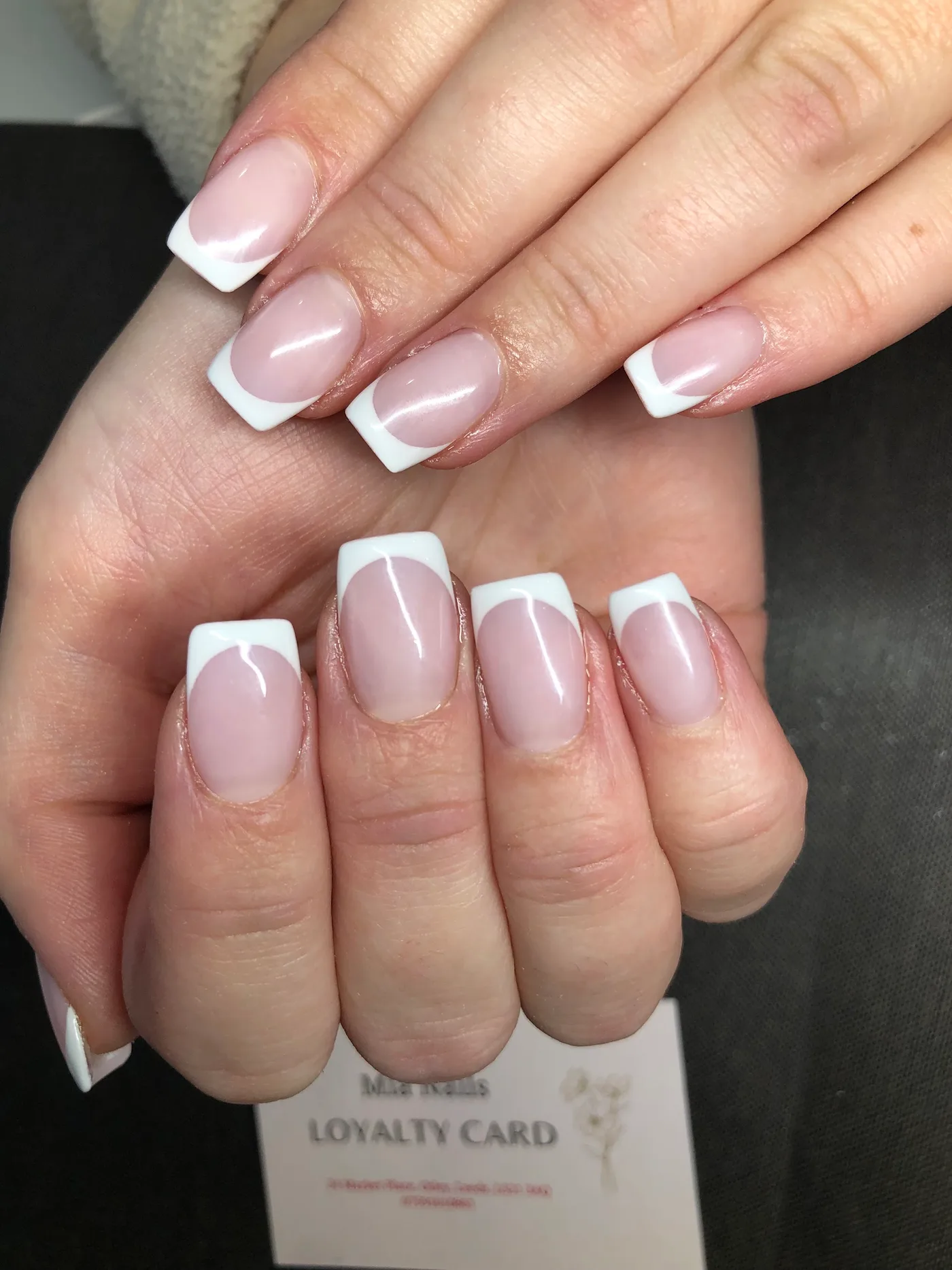 Glossy pale pink nails with crisp white tips, finished at Mia Nails