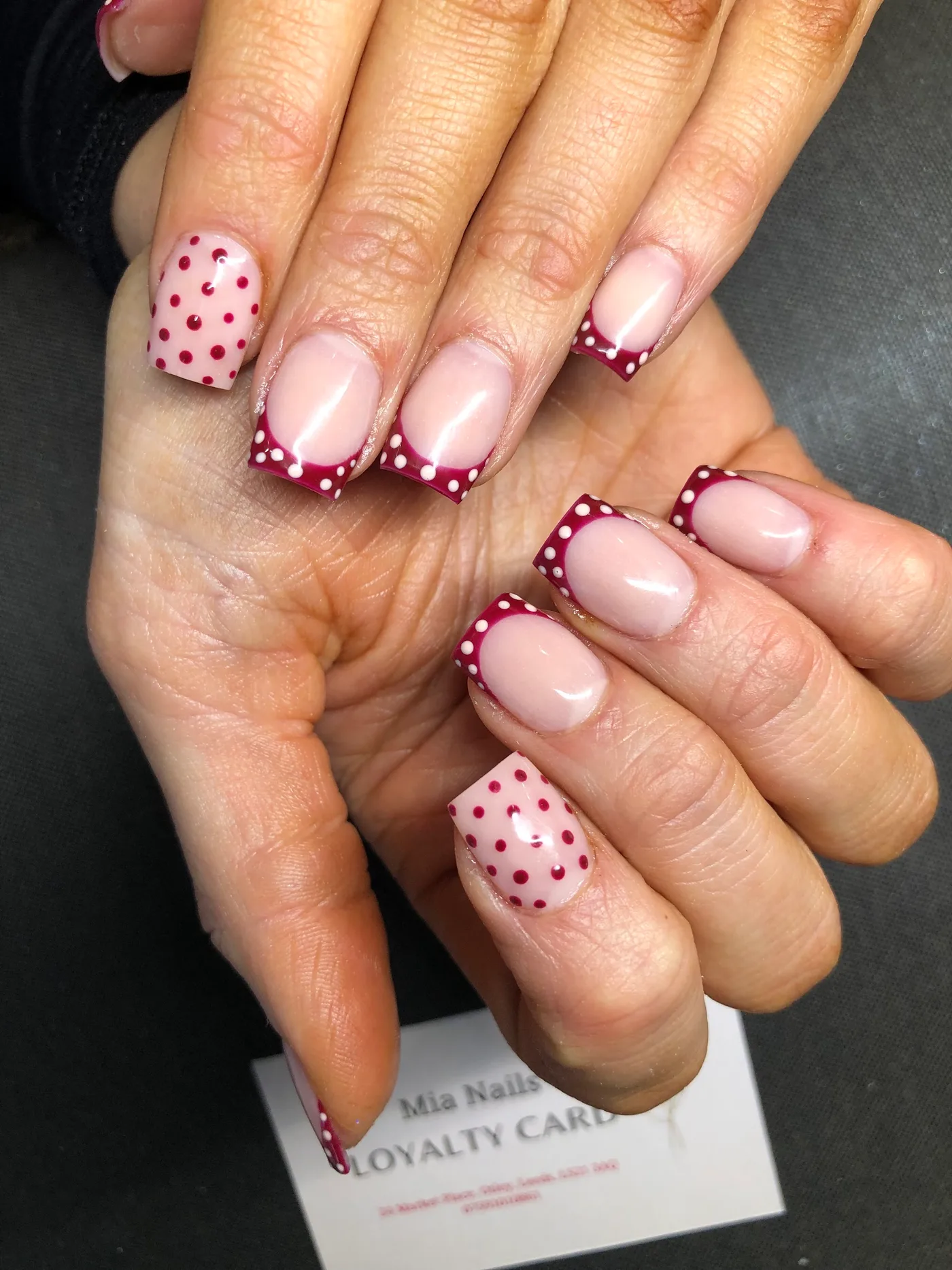Pink nails with burgundy tips and polka dots